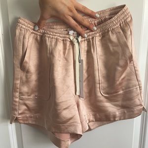 Mélissa Newton Women’s blush satin shorts with drawstring.